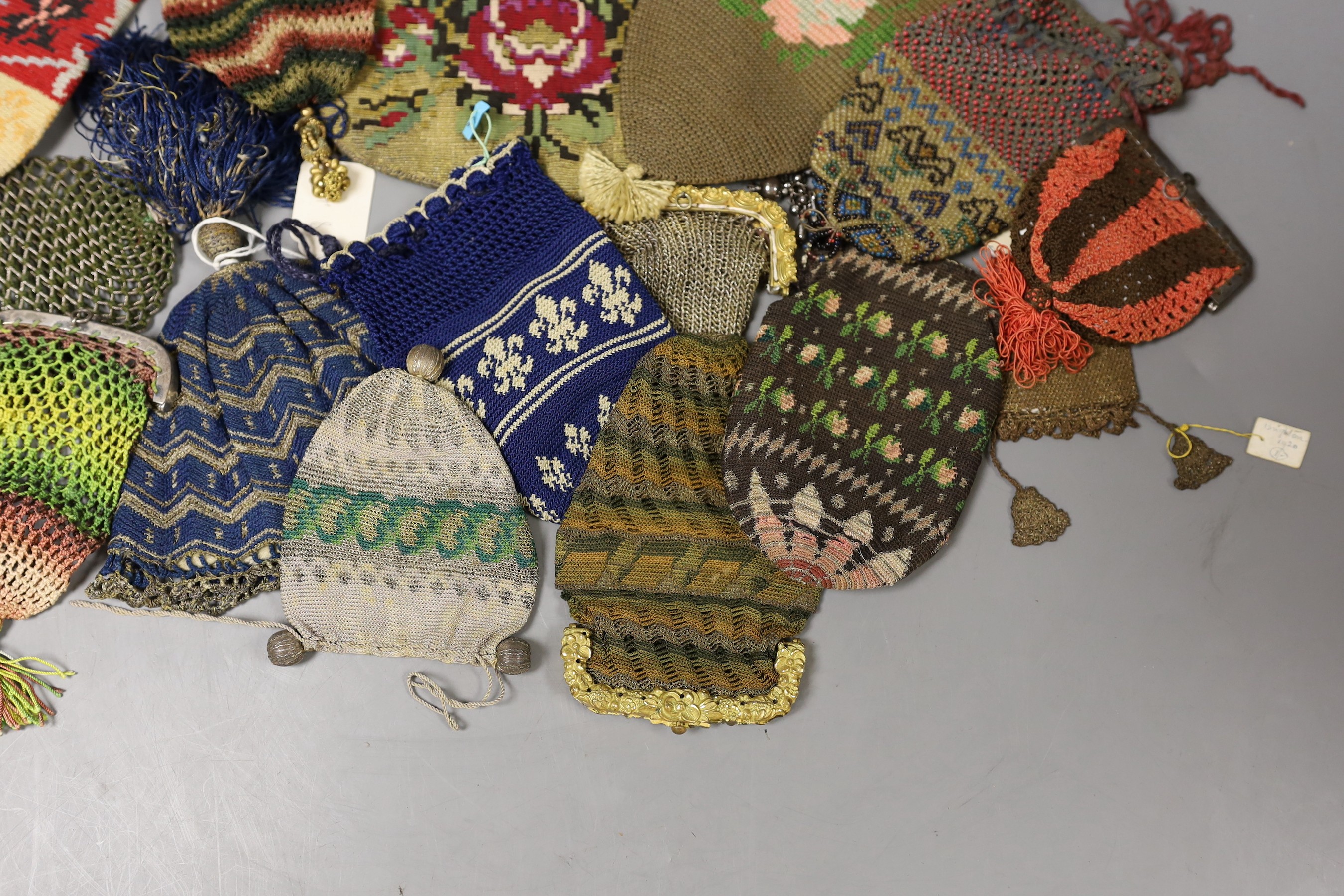 Sixteen mixed 19th century knitted and crochet purses, misers purses, reticules and a woven gilt metal bible bag